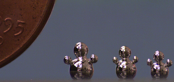 free-standing structure made of liquid metal compared to the size of a penny